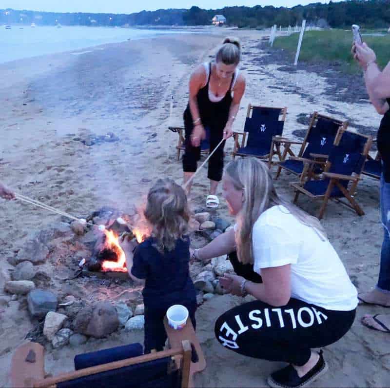 Au pair and host kid grilling marshmallow